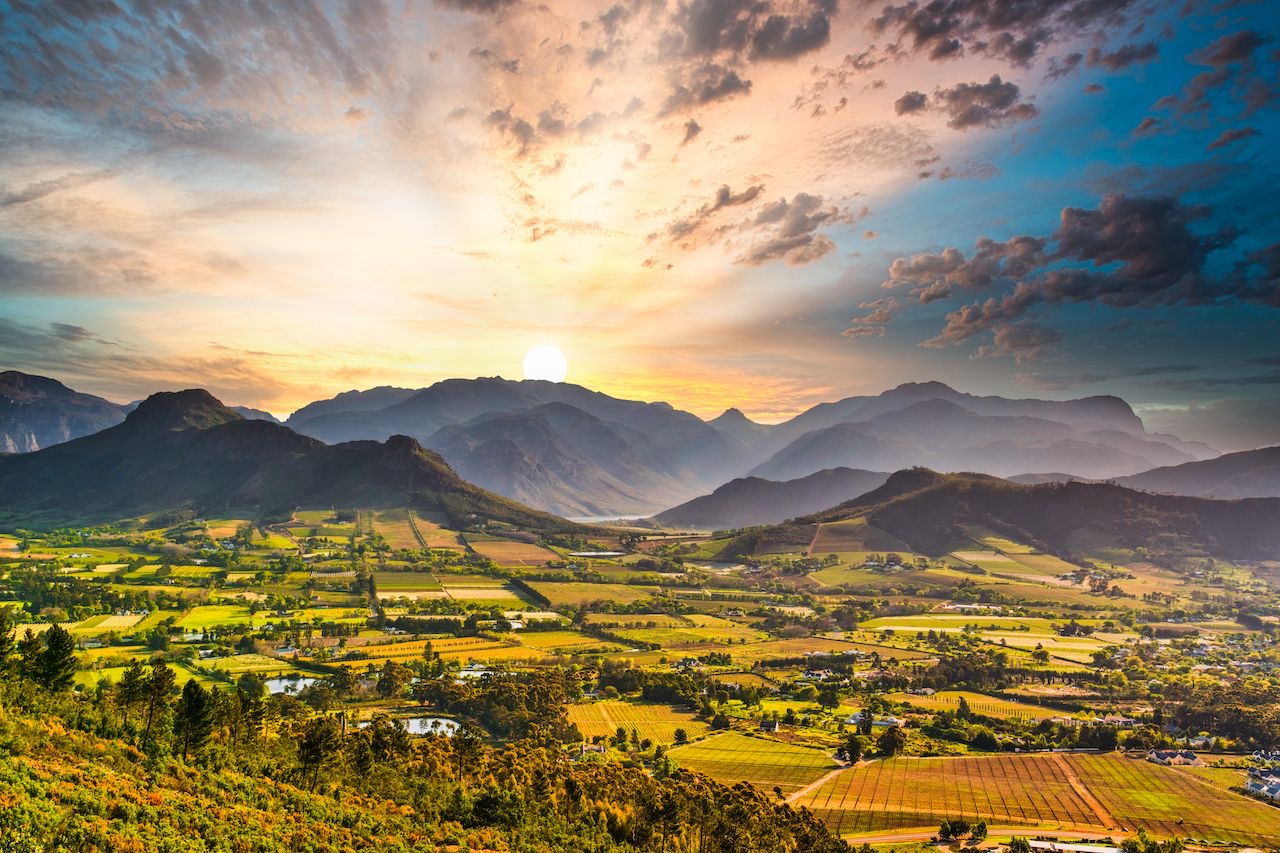 Sunset over vineyards and mountains in the Franschhoek valley, Cape Winelands